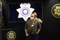 Sheriff Hanlin places the Sheriff's Citizen Medal of Valor around Scott Pettibone's neck