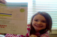 Teagan Devlin is proud to show off her math homework to the Zoom camera.