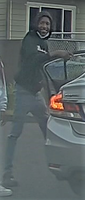Photo 1 Suspect 1 standing by car