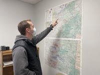 An employee with the Oregon Department of Forestry is at work in a temporary new office in Stayton 16 months after the agency's Lyons office burned down in the Labor Day 2020 wildfires.