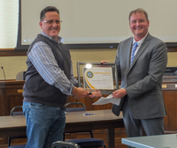 Henry Idica, Camp Rilea training site manager, receives a plaque from Clatsop County Commission Chair Mark Kujala at the Wednesday, Jan. 4, 2023 Board of Commissioners work session.