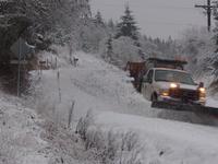 A Benton County Public Works pick-up plows snow off a County road.