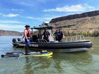 Stand up paddler interacting with the Oregon State Police on Lake Billy Chinook