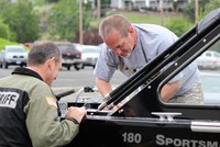 A deputy inspects a boat at a previous boat inspection clinic.