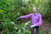 A volunteer helps clean up the Clackamas Community College Environmental Learning Center.