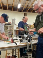 Repair Clark County volunteers Fred Davis, Les McKown and Zach Thomas sharpen dull knives and tools at the January 2020 repair event. 