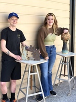 Felix Coe (left) and Carly Thompson (right) pictured with their ceramic sculpture