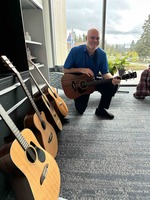 Casey Sims, counselor at Clackamas Community College, poses with guitars destined for locations around campus. This photo, by Gabriel Lucich, won first place for feature photo at this year's ONPA Collegiate Newspaper Contest.
